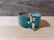 Load image into Gallery viewer, Beaded Cuff - Feather on dark turquoise
